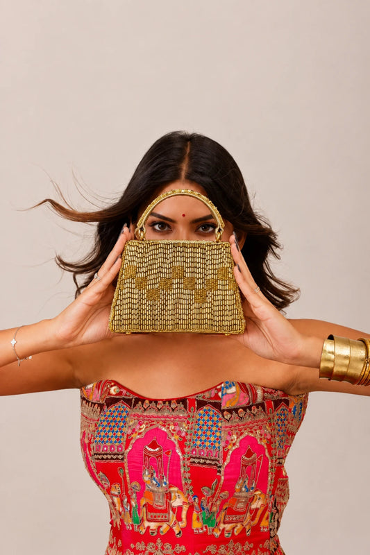 Designer clutch bag for wedding guest styling