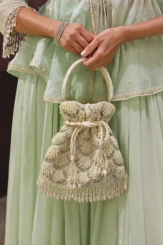 Pearl Mehendi potli bag with layered shell-inspired embellishments