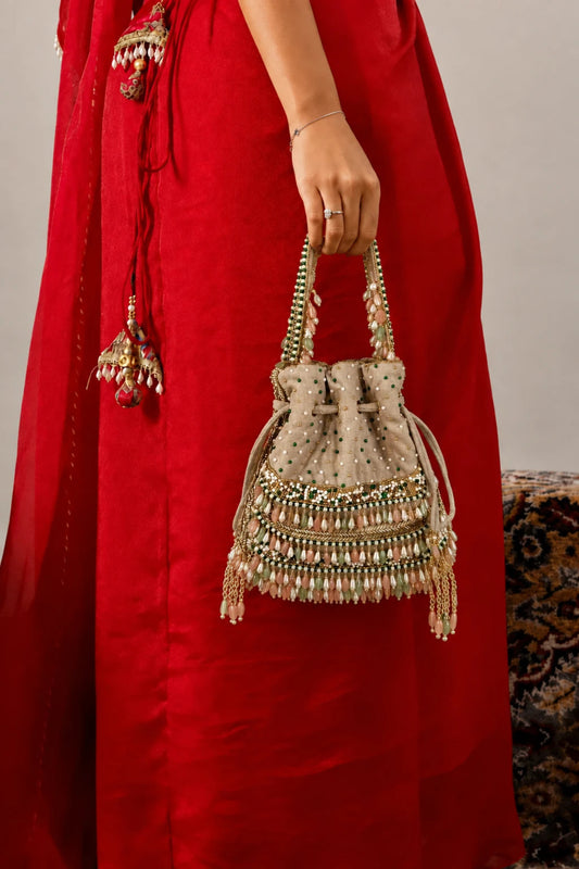 Pearl potli bag with intricate bead embroidery and gemstone detailing