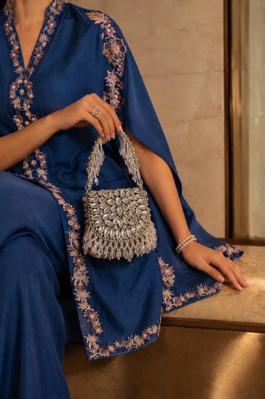 Designer silver mini handbag with elaborate kundan-inspired stonework and a structured silhouette.