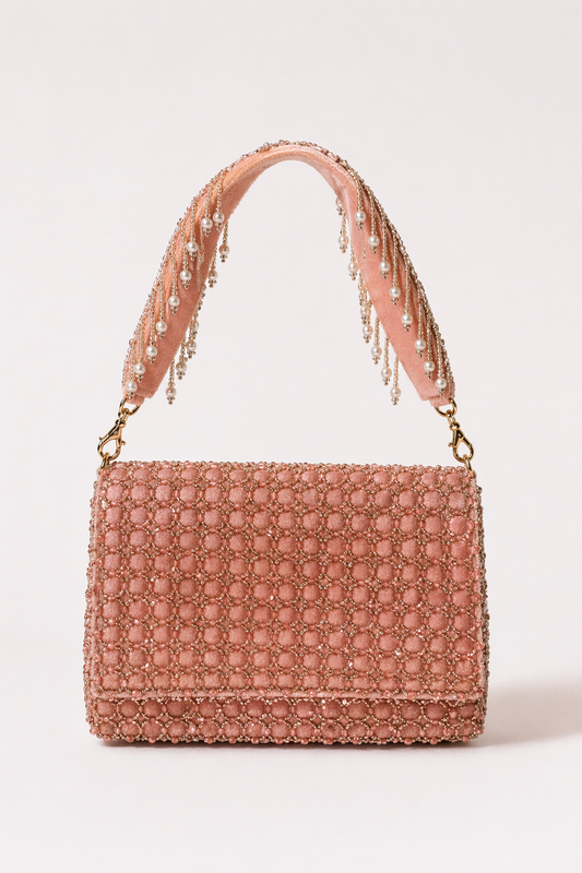 Baby pink everyday handbag with delicate embellishments and elegant pastel styling