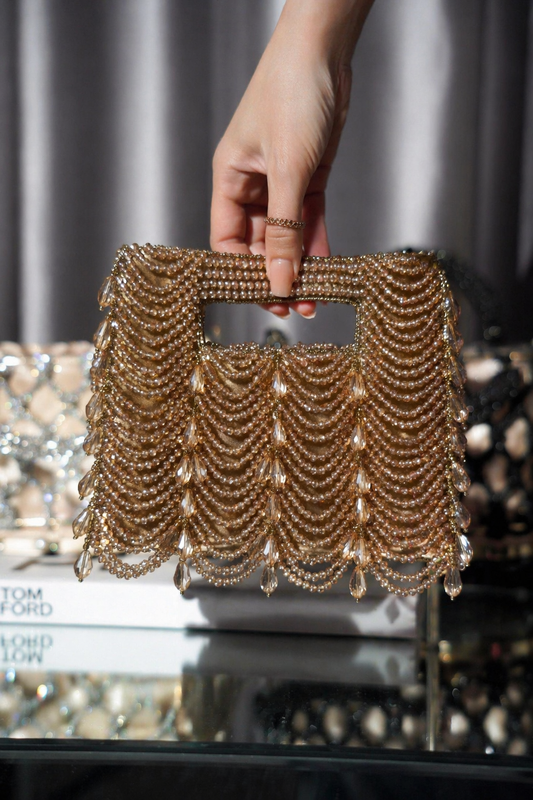 Handcrafted golden clutch bag with cascading bead detailing