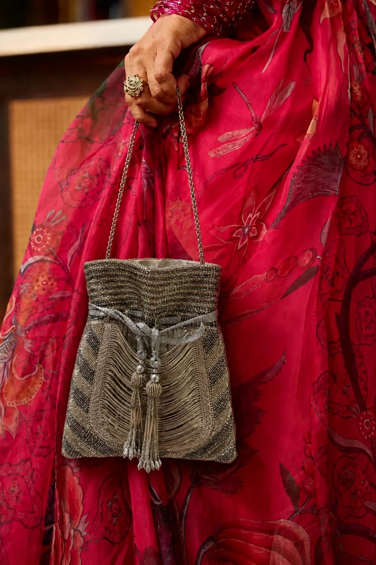 Silver potli bag paired with a saree for festive styling