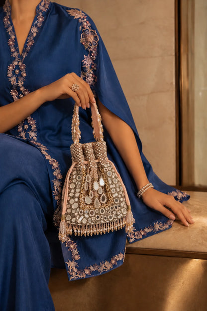 Designer baby pink potli bag with intricate mirror detailing and handcrafted embellishments for festive occasions.