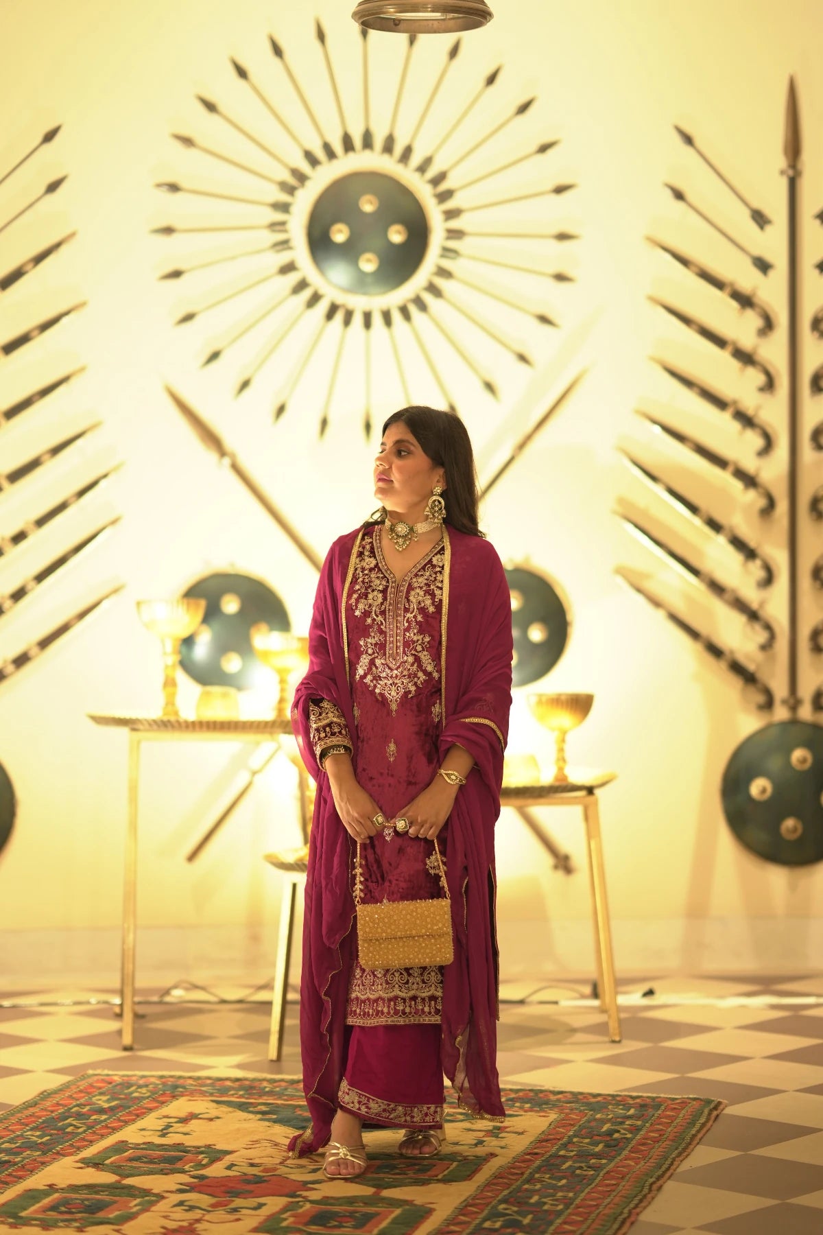 Golden shoulder bag paired with a silk saree for bridal occasions