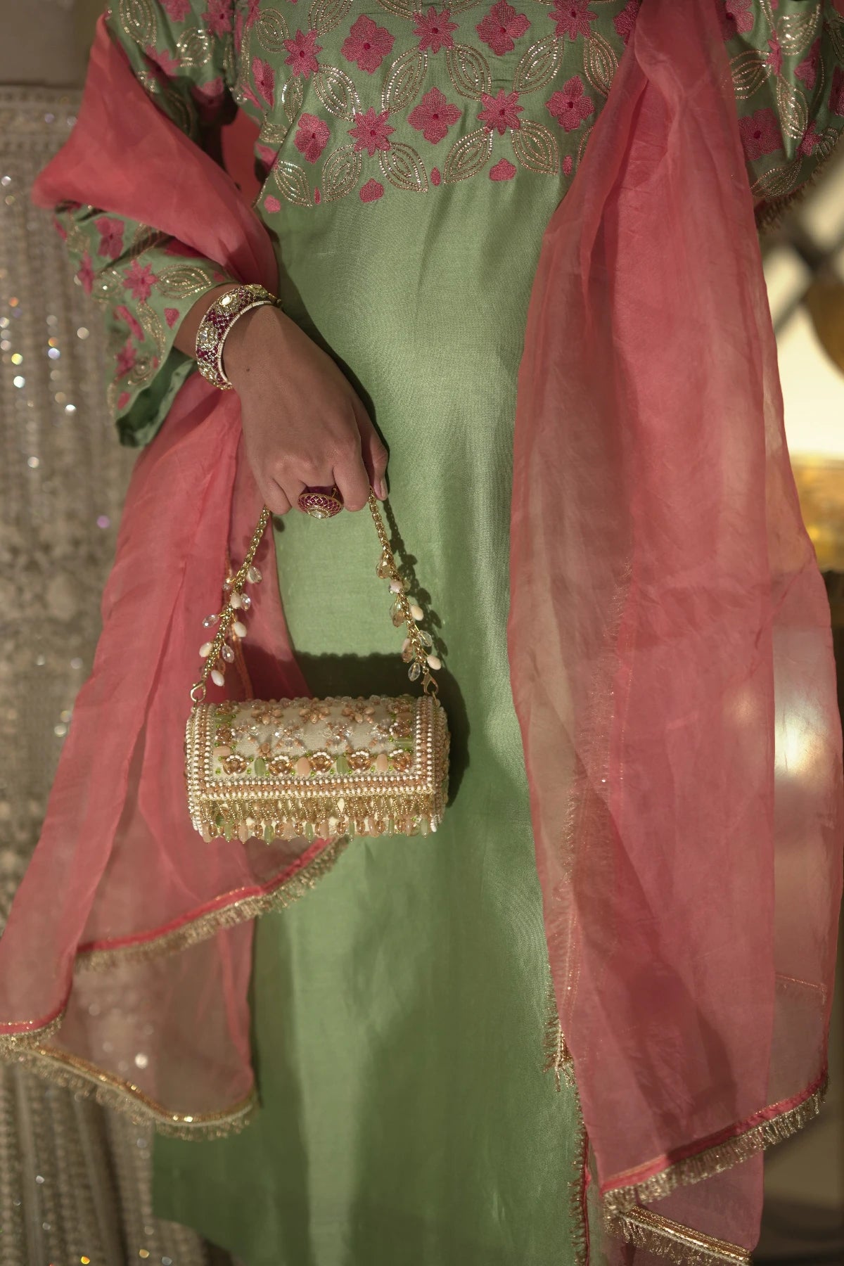 Cylindrical clutch bag styled with a lehenga for wedding functions