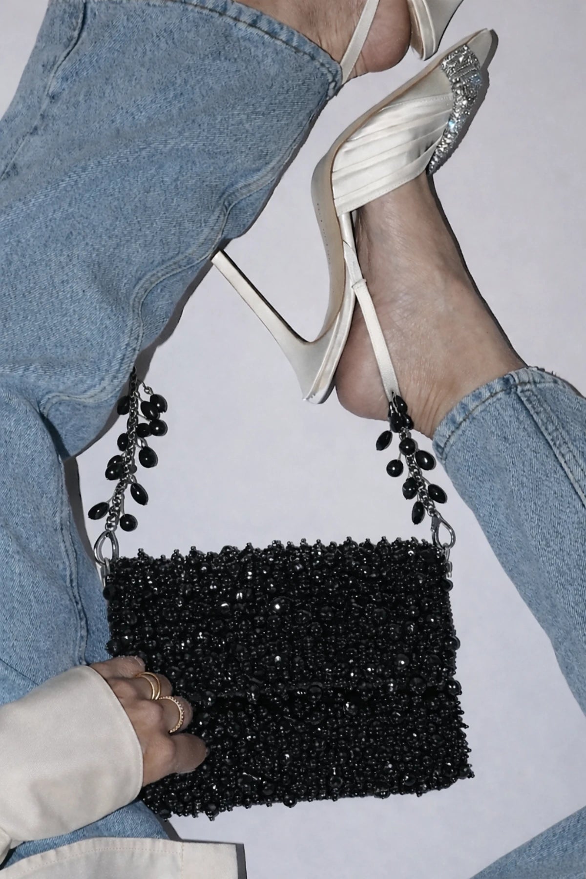 Designer black shoulder bag styled with contemporary western wear