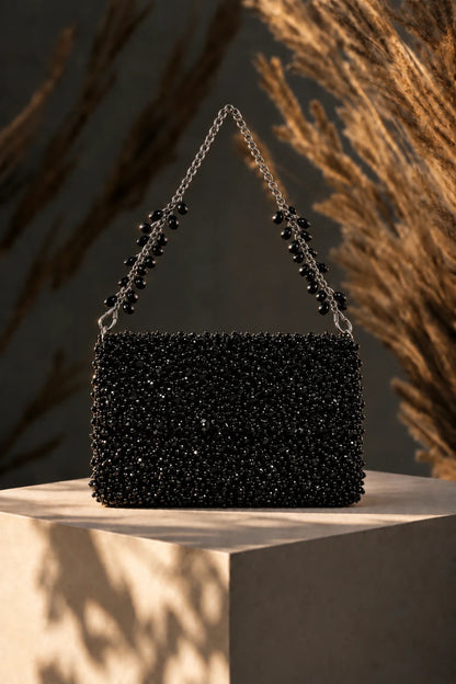 Designer black shoulder bag styled with contemporary western wear