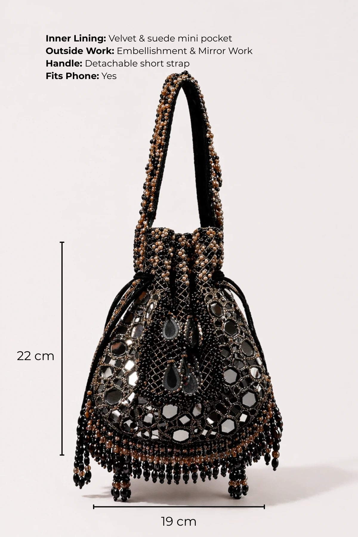Designer black potli bag styled with a lehenga for festive celebrations