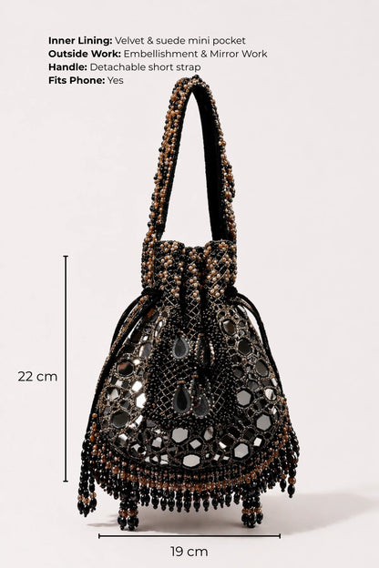 Designer black potli bag styled with a lehenga for festive celebrations
