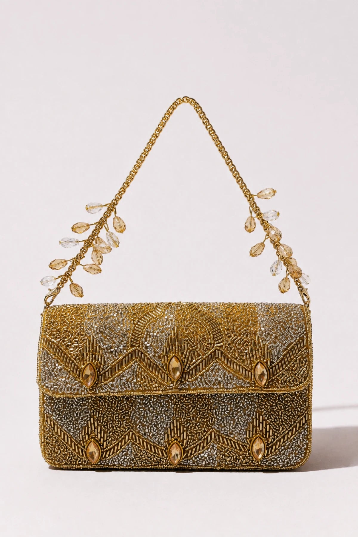 Designer gold shoulder bag styled with a festive lehenga