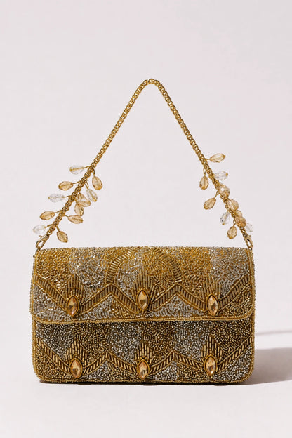 Designer gold shoulder bag styled with a festive lehenga