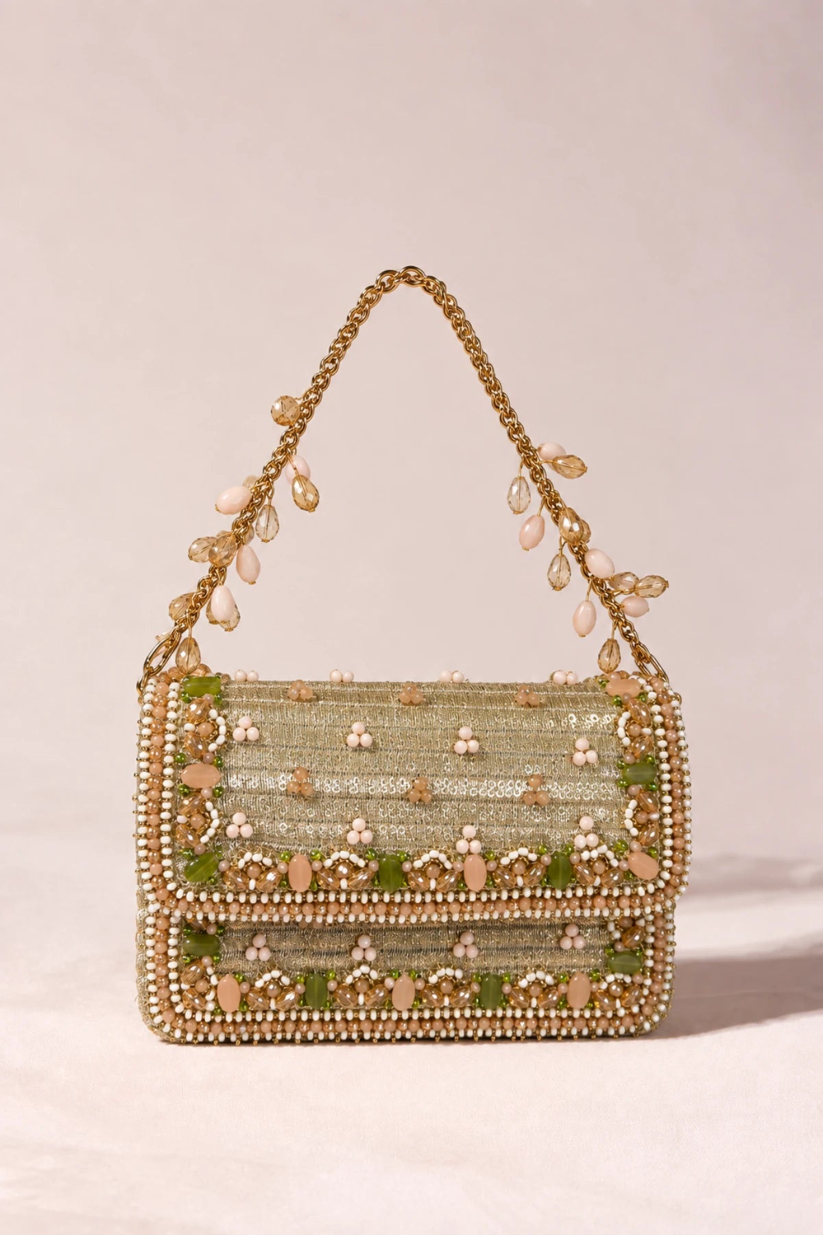 Elegant golden designer handbag with colourful handcrafted embellishments, ideal for Haldi functions and daytime wedding celebrations.