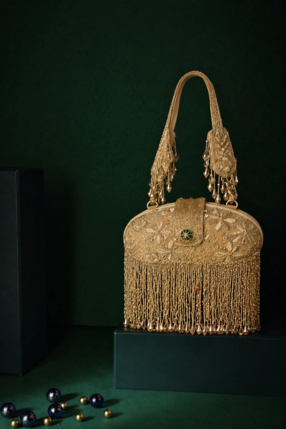 Designer golden clutch styled with a lehenga for festive occasions