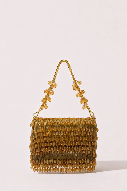 Designer golden Haldi bag styled with a festive lehenga