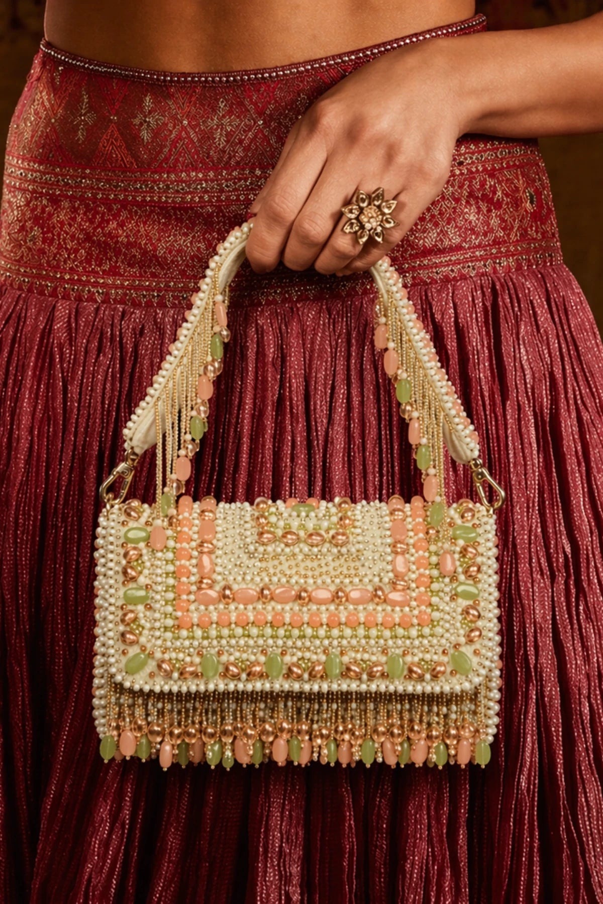 Designer pastel shoulder bag styled with a floral lehenga