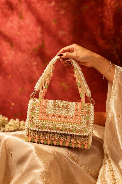 Designer pastel shoulder bag styled with a floral lehenga