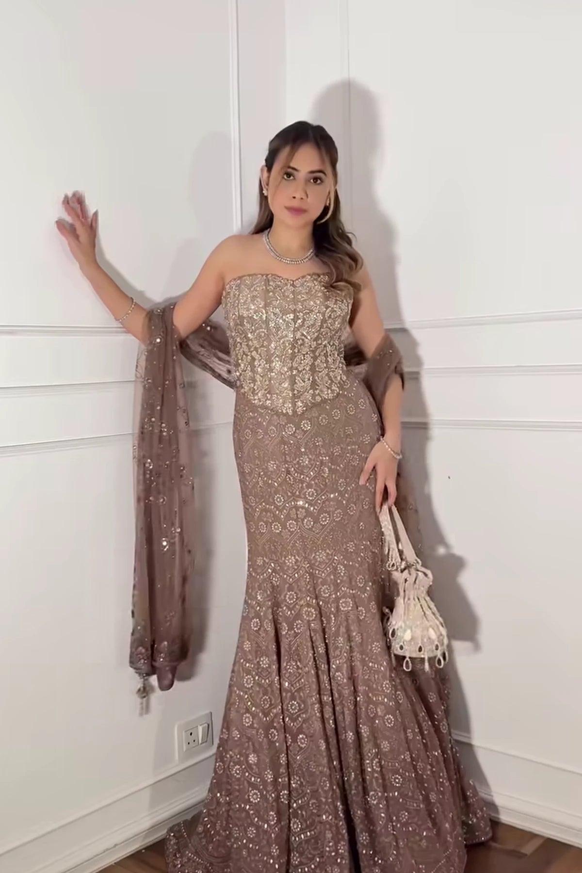 Designer golden potli bag styled with a bridal lehenga