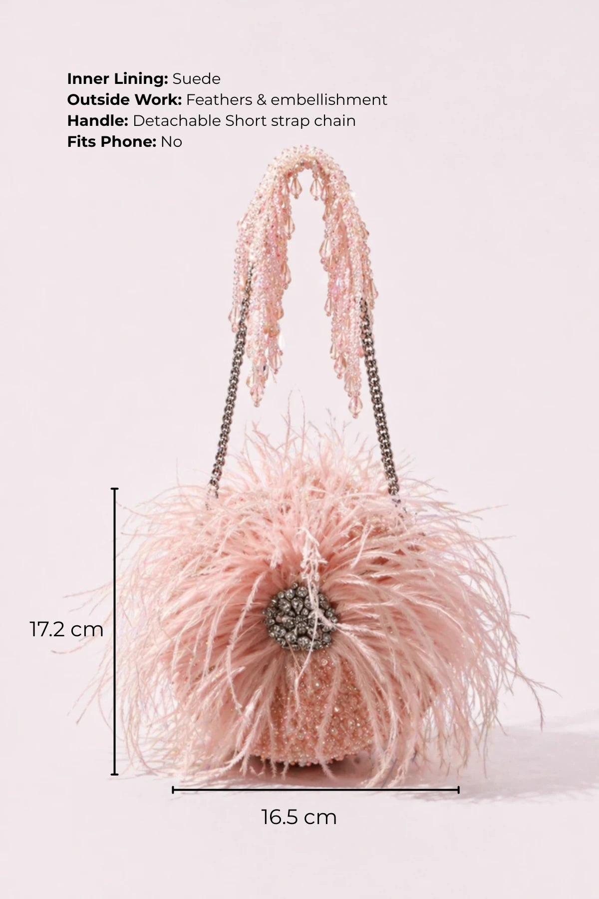 Designer baby pink round bag styled with resort wear
