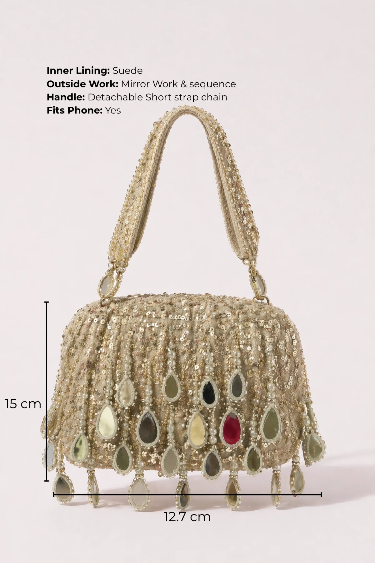 Designer silver shoulder bag paired with a festive saree