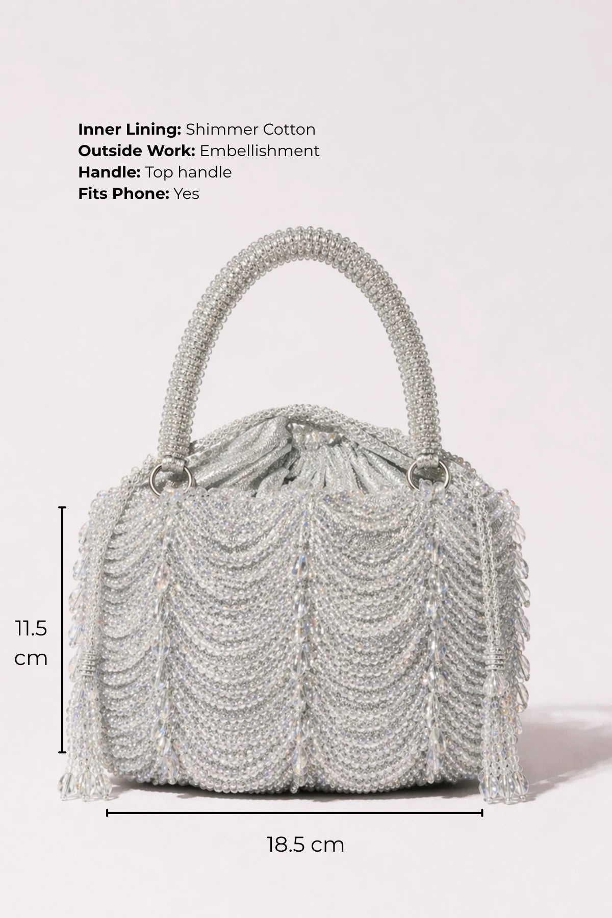 Designer silver clutch styled with a lehenga for sangeet