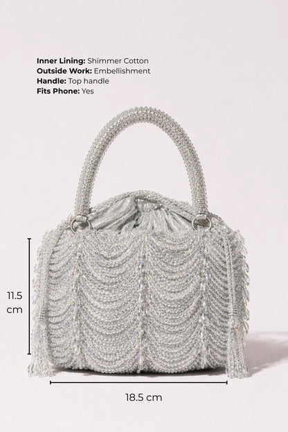 Designer silver clutch styled with a lehenga for sangeet