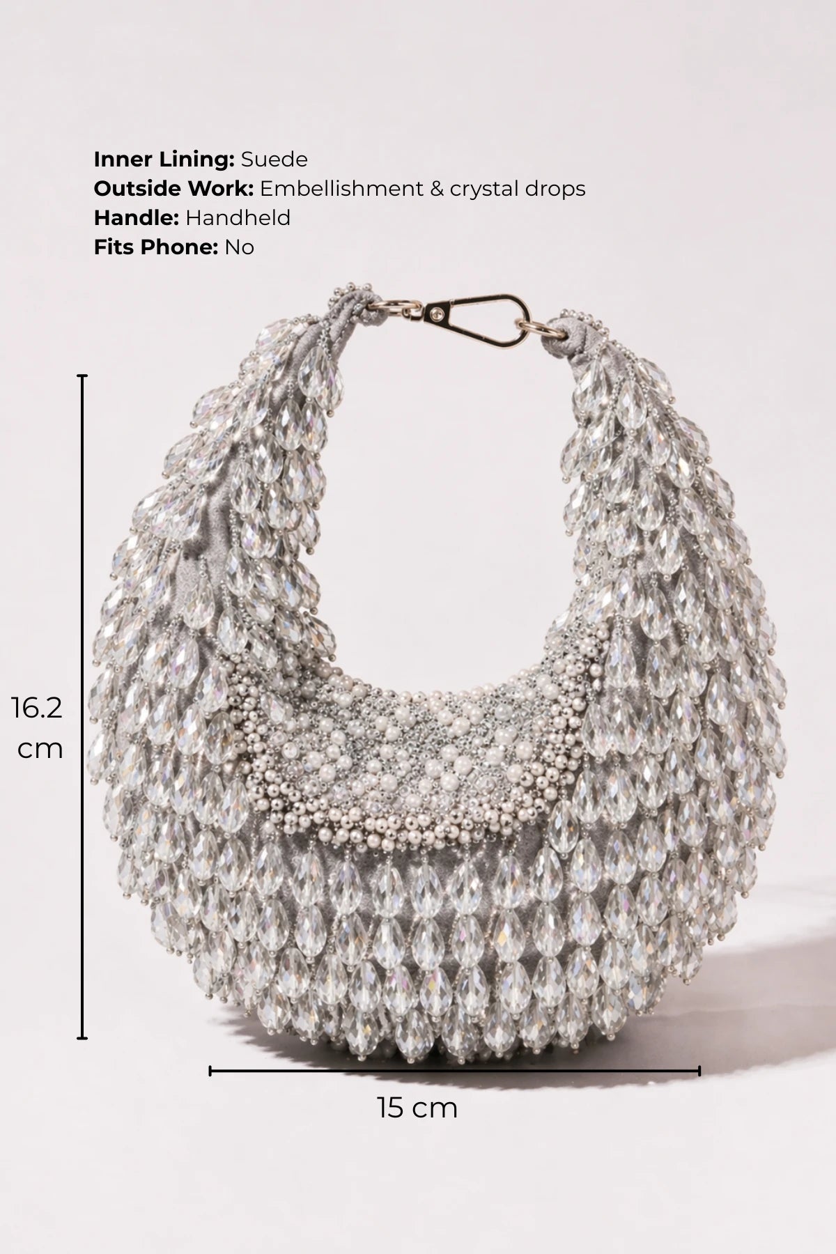 Designer silver hobo bag styled with a lehenga for sangeet