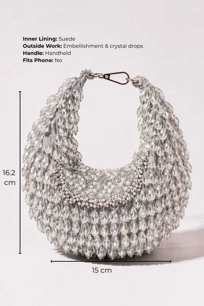 Designer silver hobo bag styled with a lehenga for sangeet