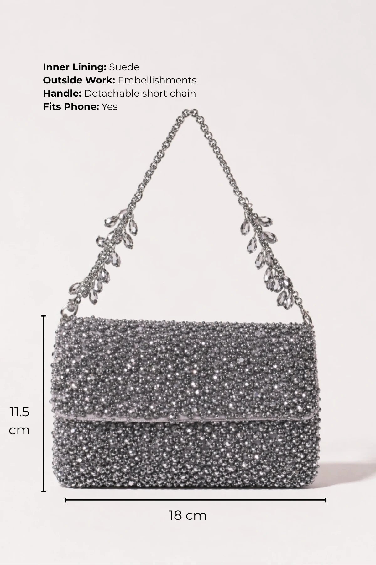 Designer silver shoulder bag styled with an evening gown