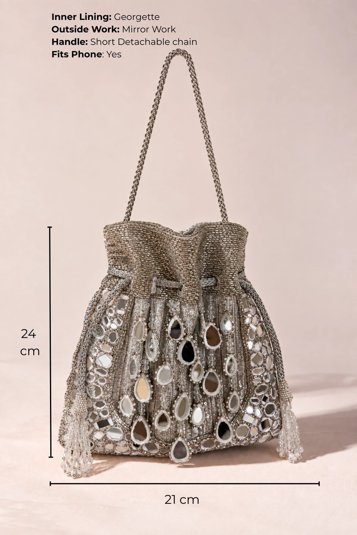 Elegant silver designer potli bag featuring traditional mirror work, ideal for Diwali and festive celebrations.