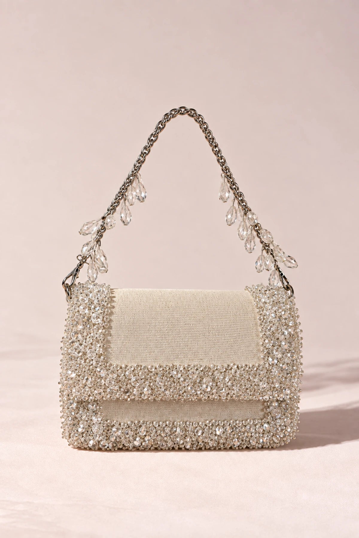 Chic white designer handbag with shimmering crystal detailing, ideal for vacations, resort escapes and summer styling.