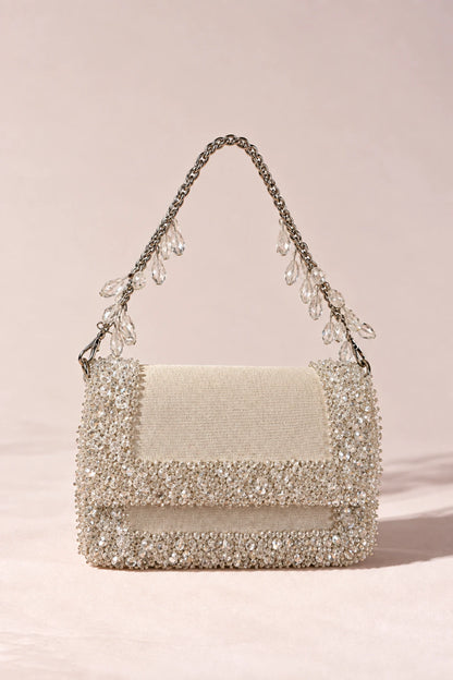 Chic white designer handbag with shimmering crystal detailing, ideal for vacations, resort escapes and summer styling.