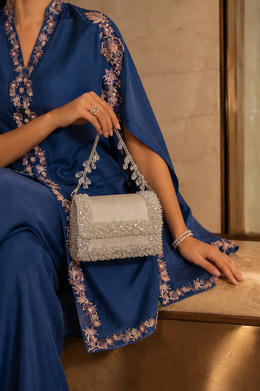 Elysia White Bag featuring sparkling crystal embellishments on a soft white base with a structured silhouette, perfect for vacation and resort wear.