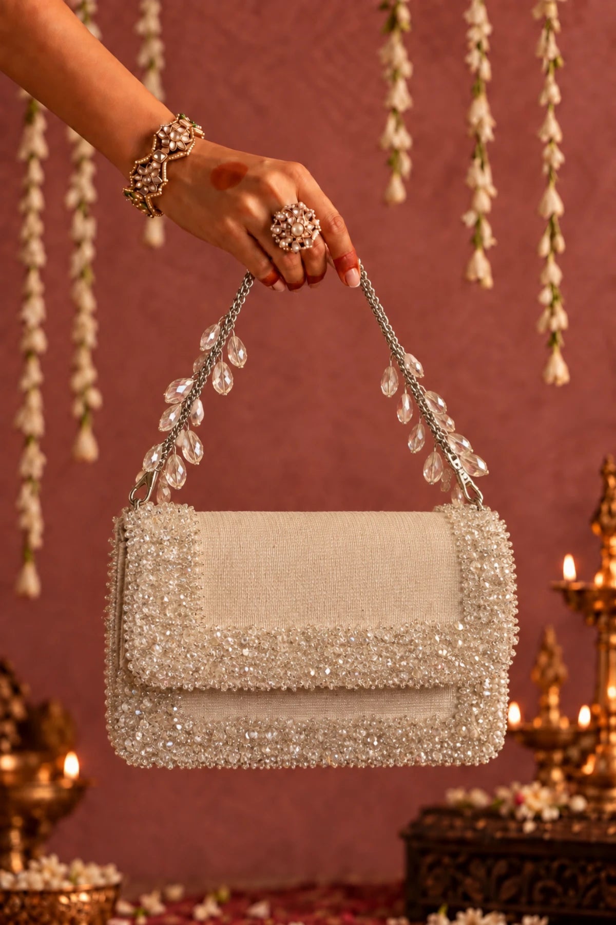 Elysia White Bag featuring a detachable embellished chain handle and sparkling crystal accents.