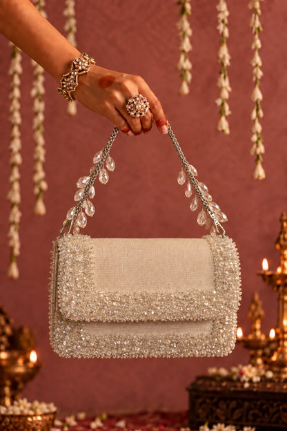 Elysia White Bag featuring a detachable embellished chain handle and sparkling crystal accents.