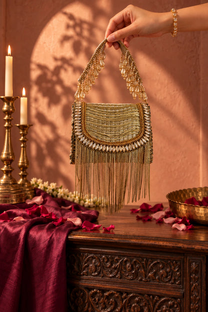 Golden metallic fringe mini bag featuring cascading embellishments and a glamorous textured finish.
