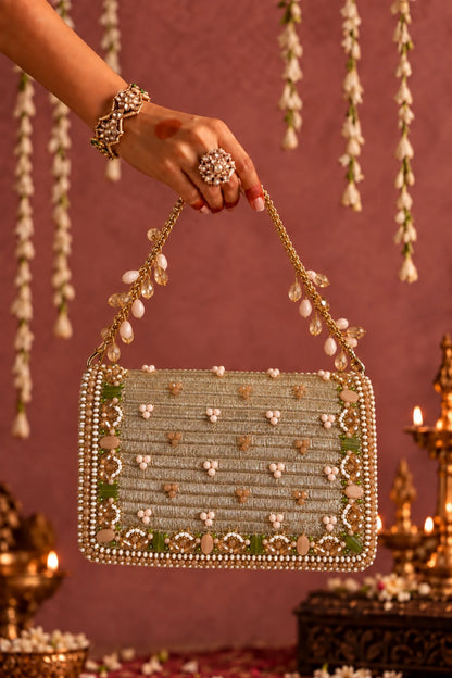 Stylish golden beaded party bag with sparkling stones, sequins and colourful embellishments for festive celebrations.