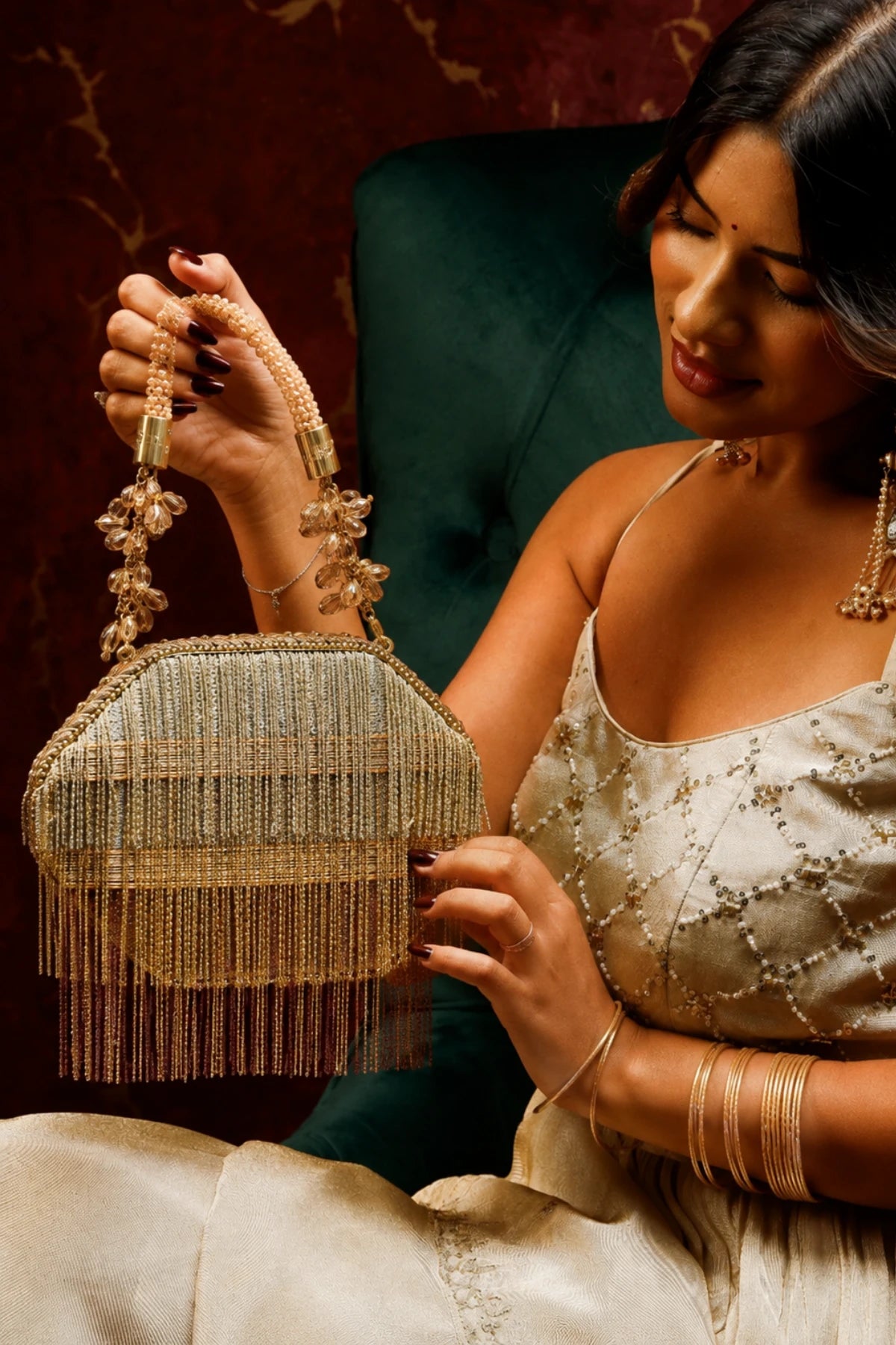 Designer golden clutch styled with a wedding lehenga