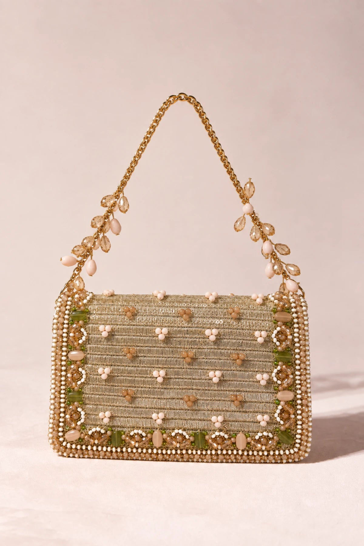Statement golden wedding handbag featuring floral-inspired beadwork in soft blush, green, white and champagne tones.