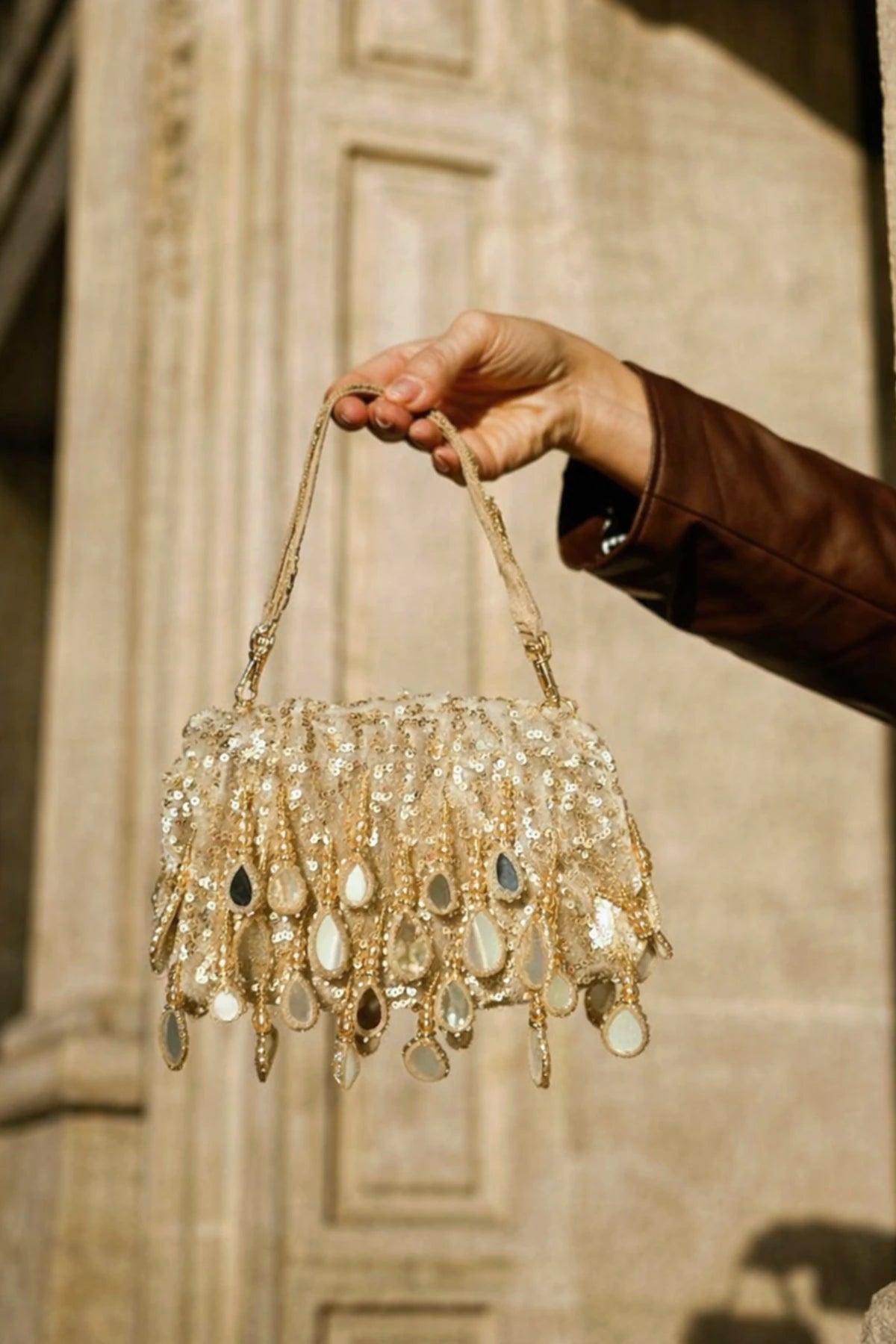 Golden shoulder bag styled with a lehenga for haldi celebrations