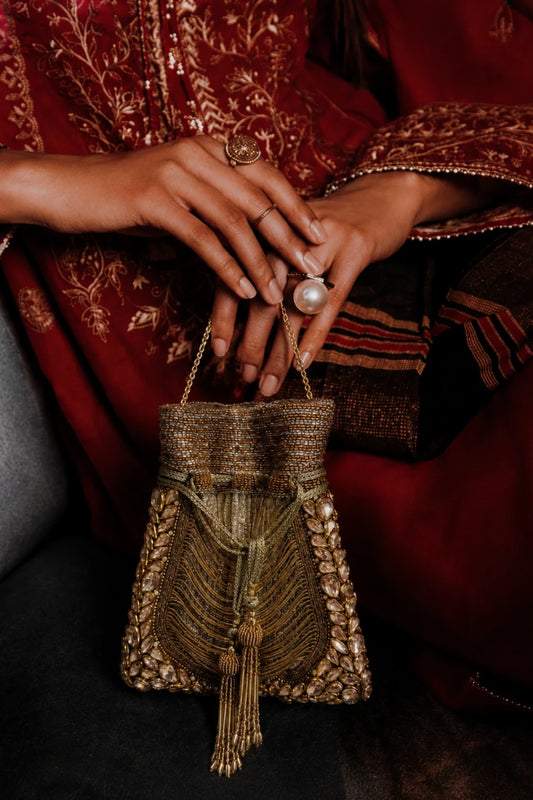 Golden wedding potli bag for women with embellished tassel detailing
