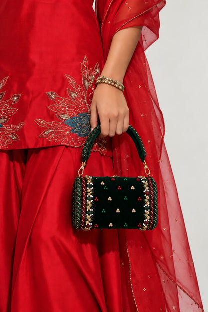 Designer green handbag with handcrafted bead, stone and pearl-toned embellishments and a spacious structured silhouette.