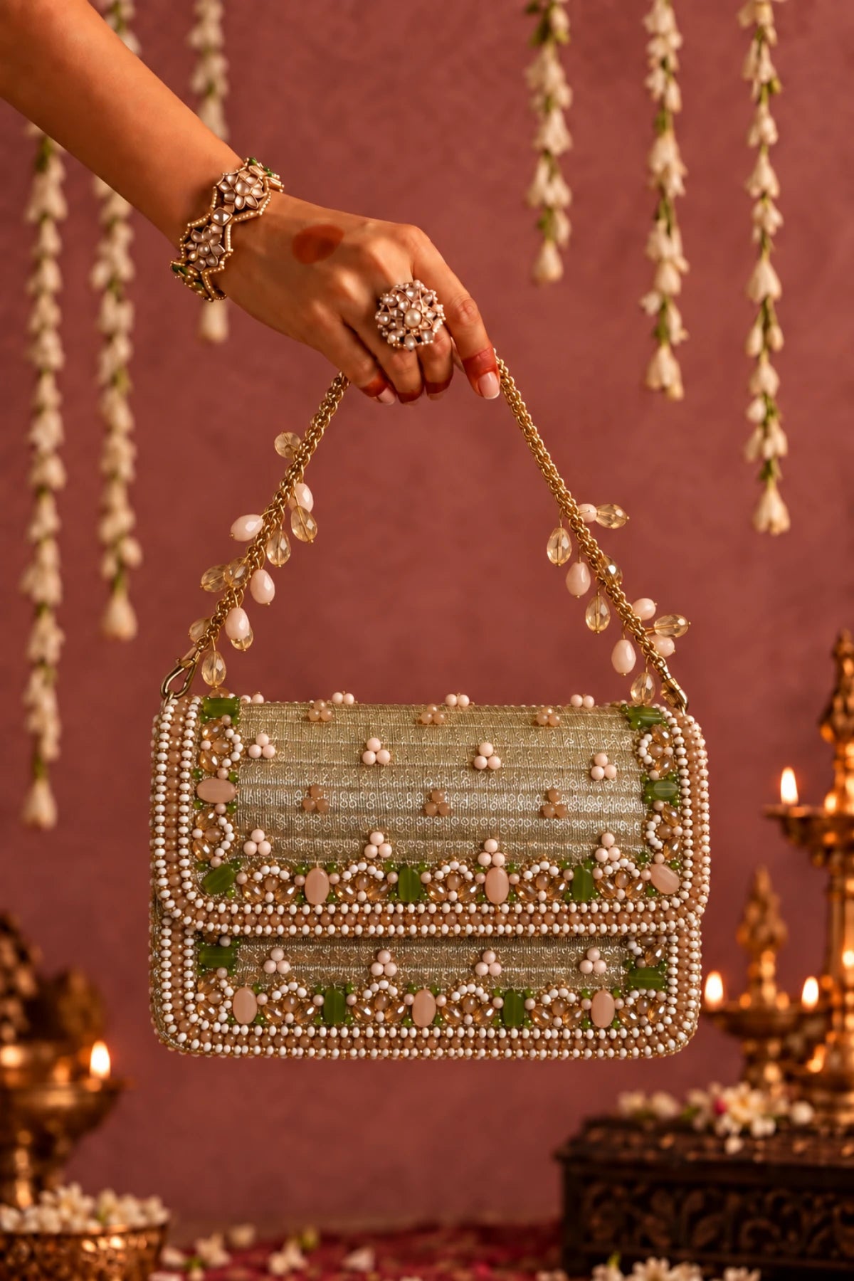 Gulshan Golden Bag featuring a detachable embellished chain handle and intricate handcrafted floral detailing.