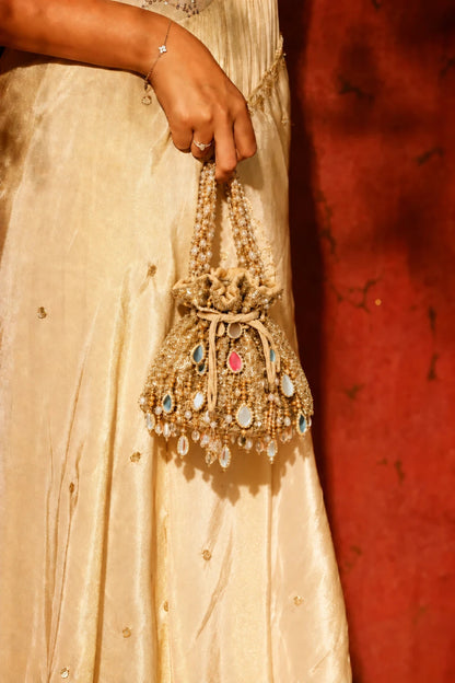 Golden haldi potli bag with mirror work for festive celebrations