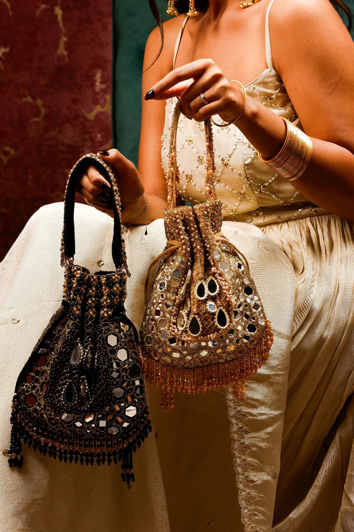 Handcrafted black potli bag with tassel detailing and bead embroidery