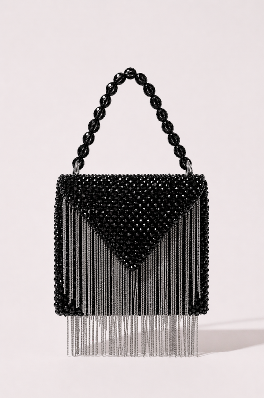 Black beaded sling bag with metallic fringe detailing and bold geometric silhouette
