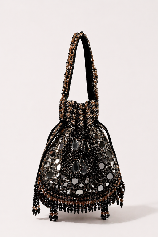 Black bridal potli bag with intricate stone embellishments and handcrafted tassel detailing