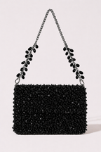 Black crystal sling bag with textured beadwork and shimmering chain detailing