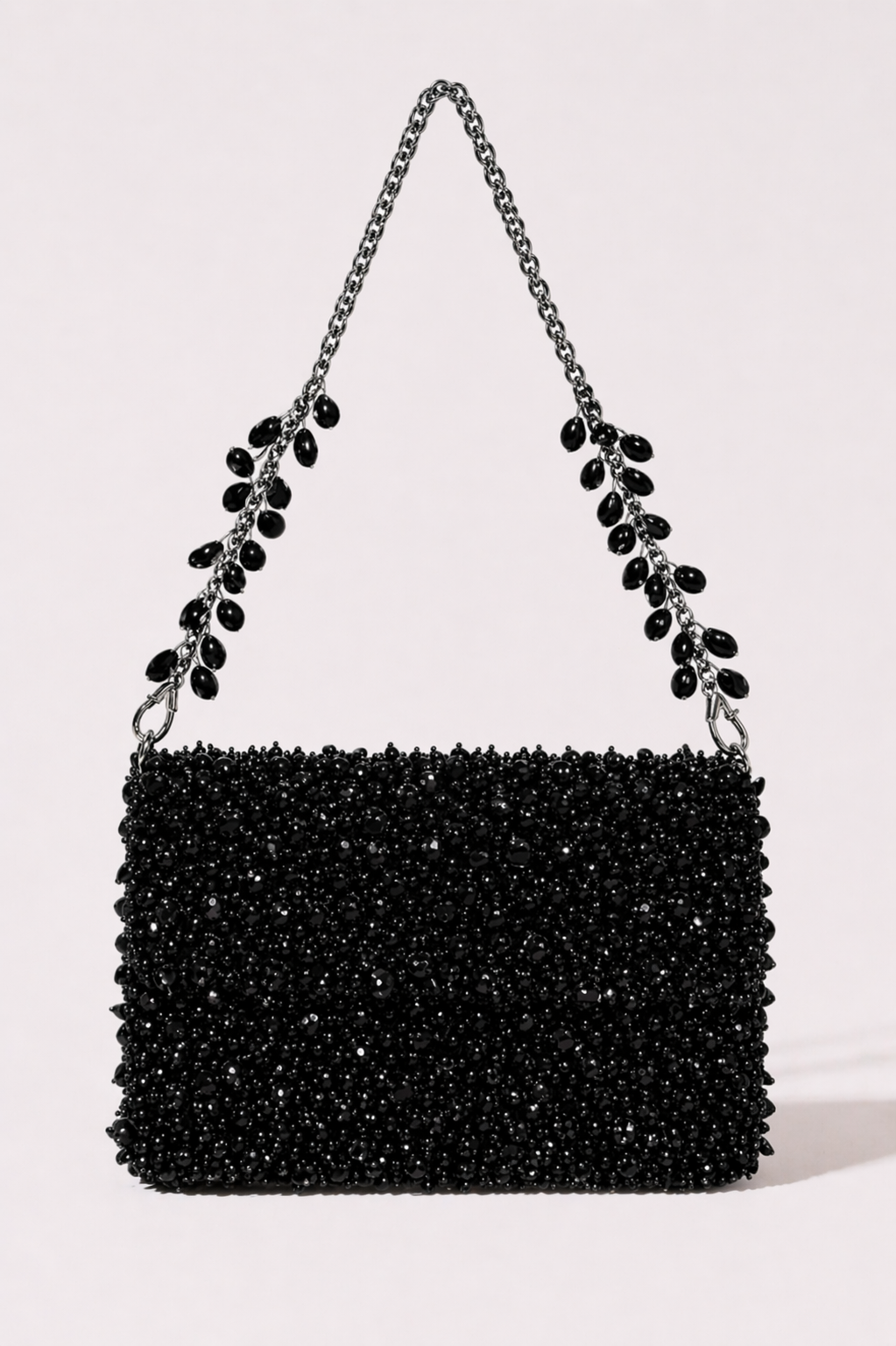 Black crystal sling bag with textured beadwork and shimmering chain detailing