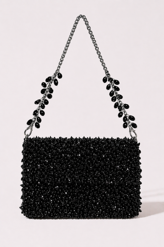 Black crystal sling bag with textured beadwork and shimmering chain detailing